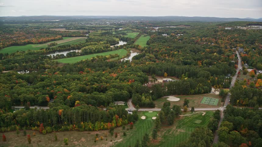 Highways cross through wooded rural countryside paralleling river