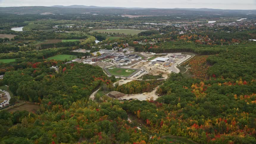 Dense woods surround manufacturing centers and town during the fall