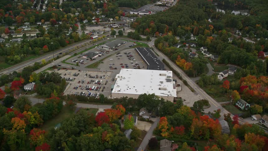 A large building is in the middle of the suburbs