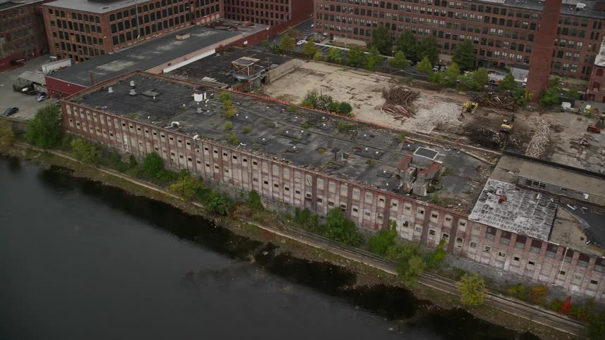 Aerial view of an abandoned building by a lake