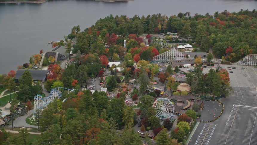 Aerial panorama of an amusement park by the edge of a lake