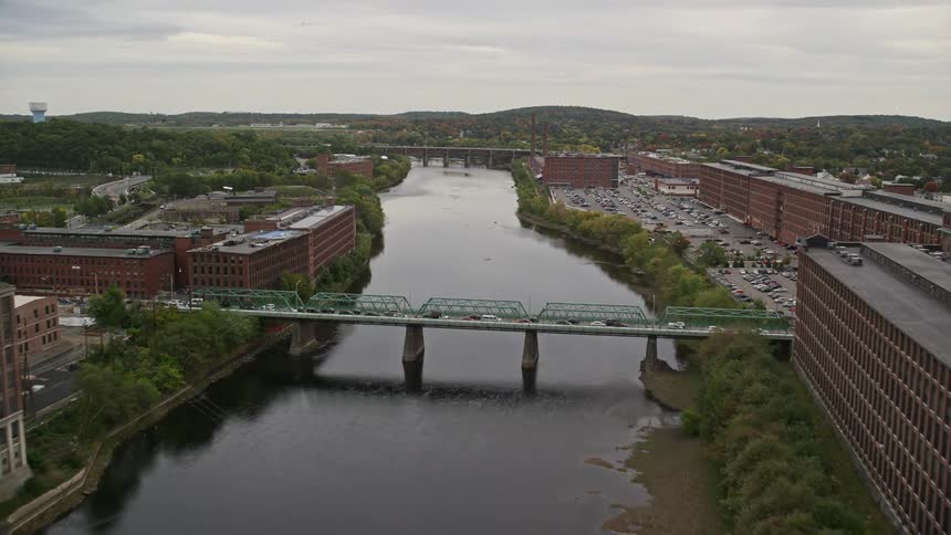 A large water channel that passes through a city with pointes and commercial buildings
