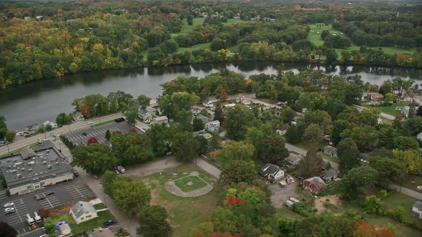 Aerial view of riverfront houses surrounded by trees