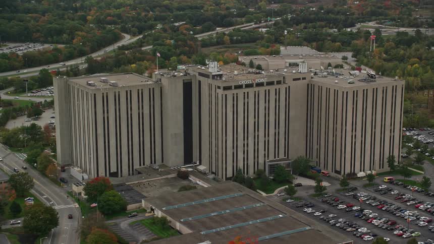 Cars drive past the office building