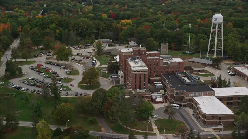 Aerial view of building water tower and parking lot on fall day