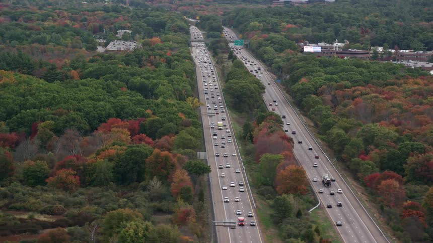 Aerial view of a twolane highway in the middle of a forest