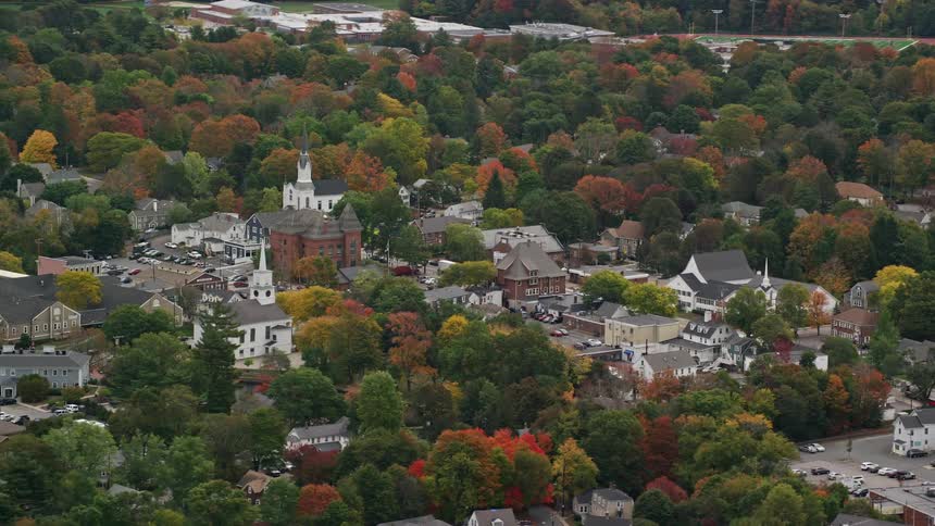 Aerial view of a town near autumn forest