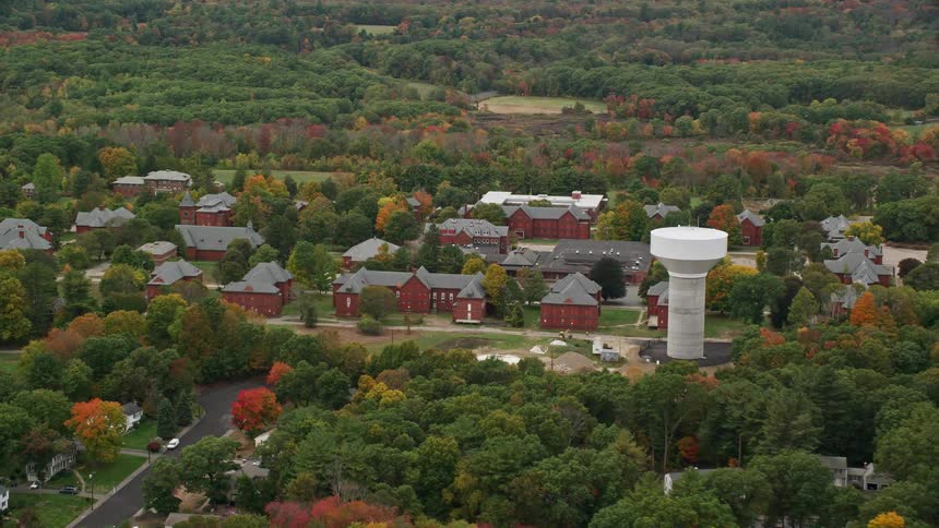 Aerial view of the medfield state hospital previously known as the medfield insane asylum with vibrant autumn foliage under cloudy skies
