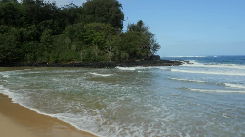A man is running on the beach with a surfboard
