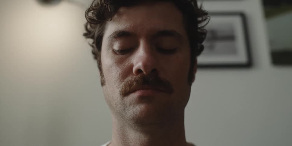 A man gets distracted while meditating