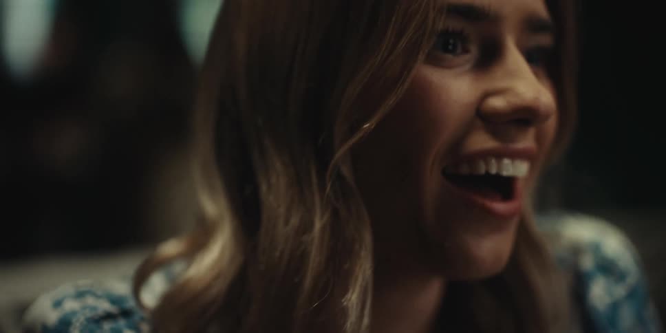 Woman smiles and laughs as she sits talking