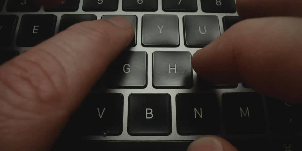 Hands of a person typing on a laptop