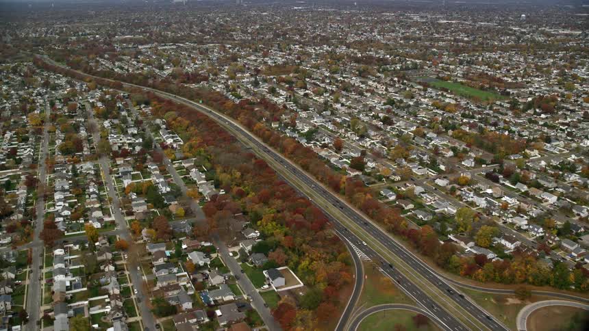 Aerial view of a highway crossing a large suburban city