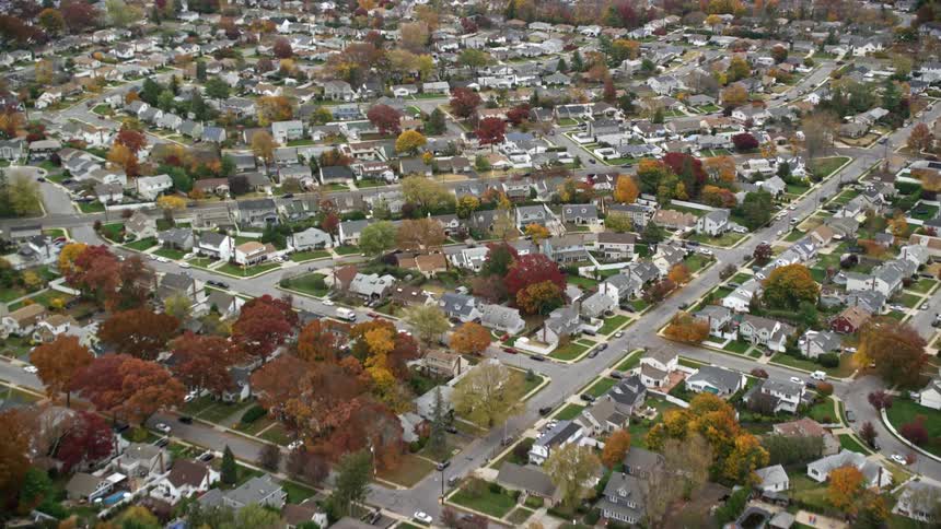 A residential neighborhood is filled with many homes and trees