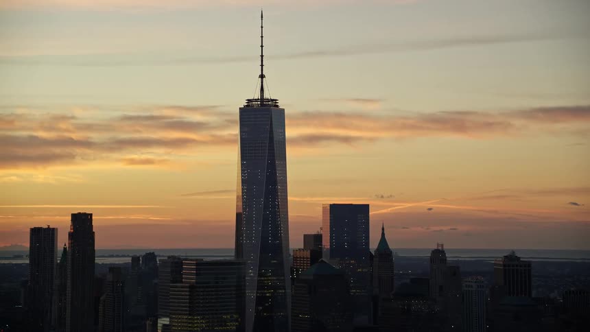 The silhouette of the one world trade center building stands tall against the sky