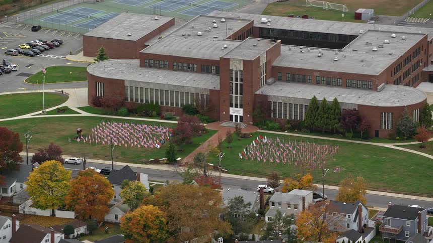 Aerial view of a school facing an urban city