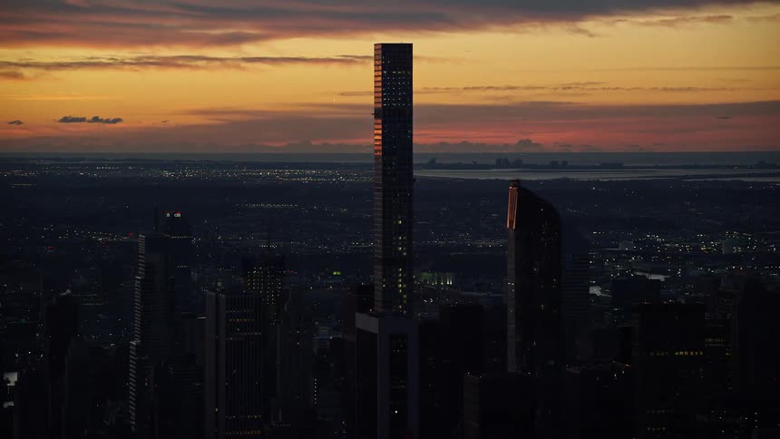 A city skyline with skyscrapers and other structures during sun down