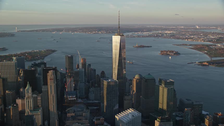 Aerial of skyscrapers at waterfront at sunset