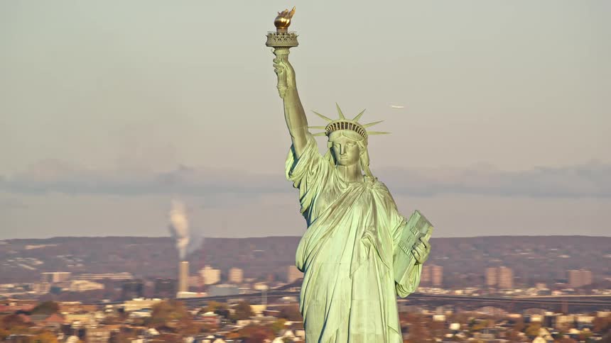 Statue of liberty towers over hazy urban landscape