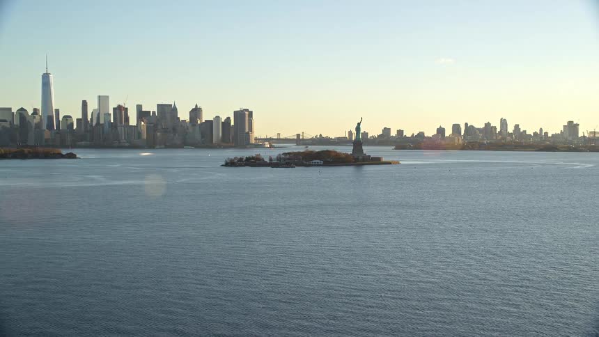 Landscape of buildings and skyscrapers close to the sea in new york city at sunset
