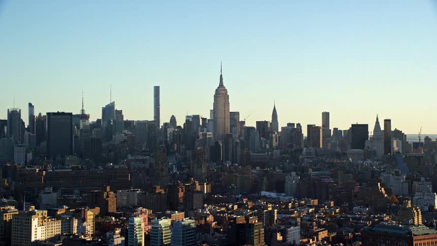 A metropolitan region with several tall buildings behind and smaller buildings in front