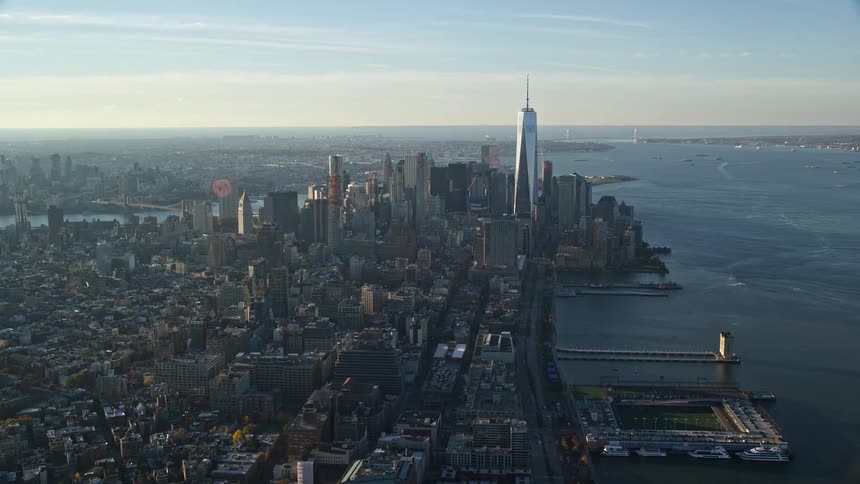 Aerial view of a metropolitan city by the sea with a dawn sky