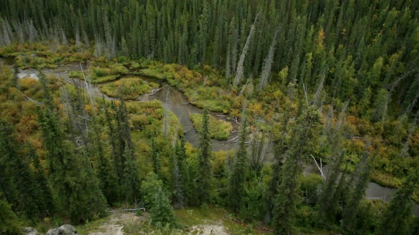 Over the edge of a cliff is a small stream below