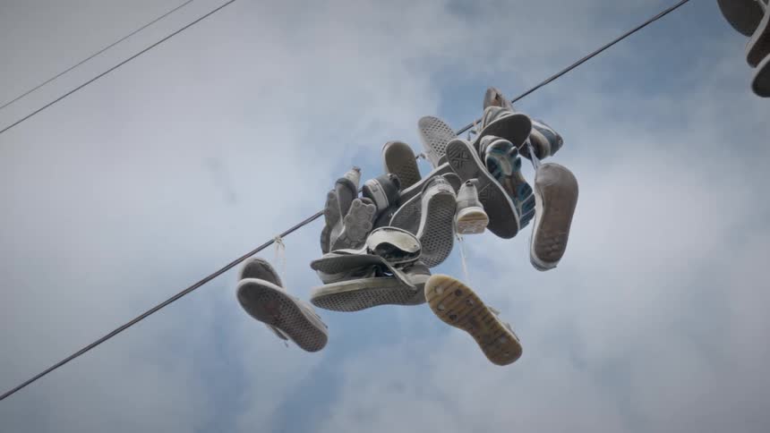 Power cord with tied sneakers