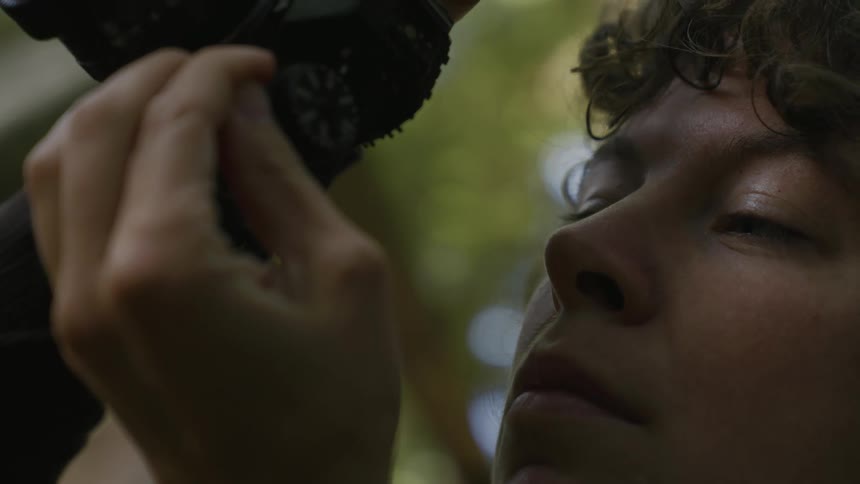 Portrait of a man taking photos in nature