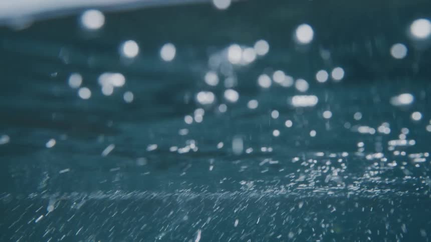 Underwater bubbles rise to the surface as sunlight shines from above