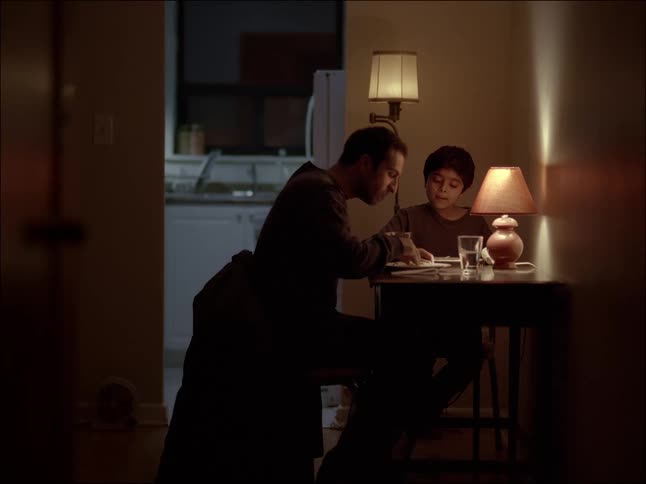 A man and a boy sitting at the table and eating