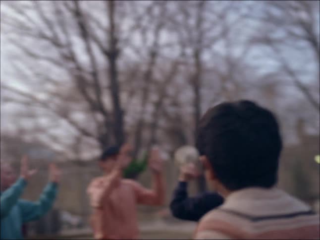 A group of some boys playing with a soccer ball