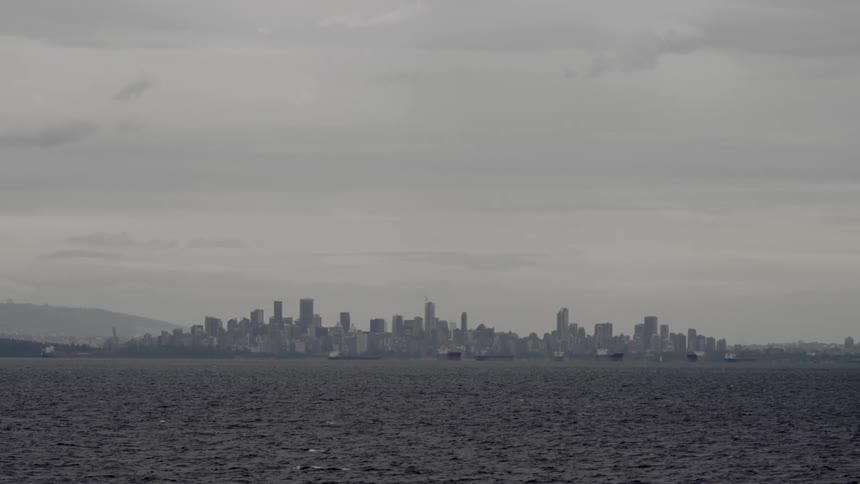 Vancouver Skyline seen over the sea on a cloudy day