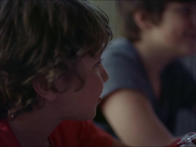 A young lady is having a fun time with her son