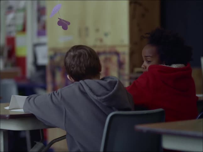 A clip of two pupil a male and a female in a classroom