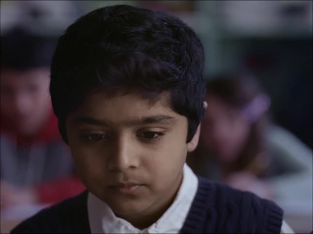 Sad student boy in the classroom