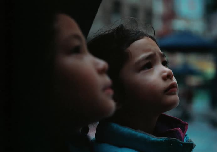 Emotional Close-up of Two Asian American Children Watching Something Captivating in the Sky