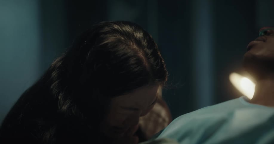 A woman is crying over a hospital patient