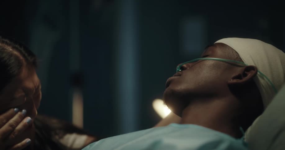 A woman is crying by the hospital bed