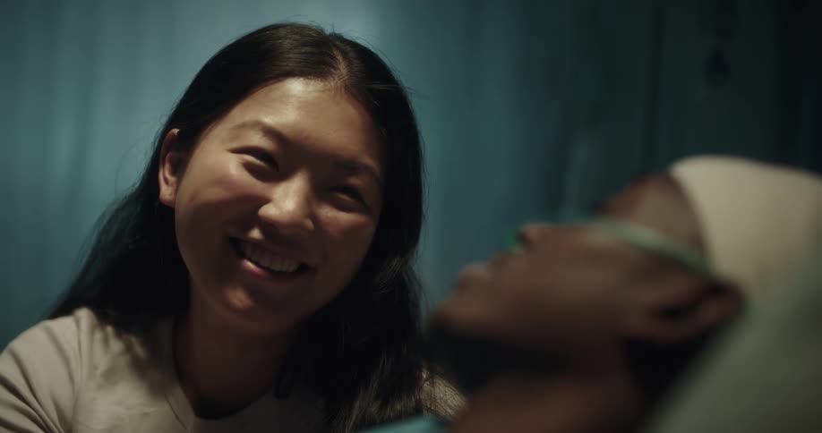 A visitor is talking with a hospital patient