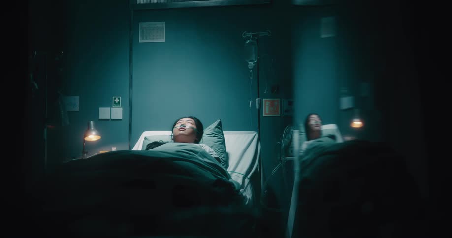 Sick lady with nose tube sleep on the hospital bed at night