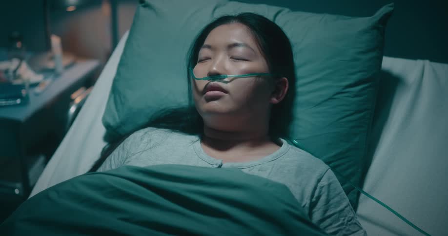 Asian woman lying on a hospital stretcher
