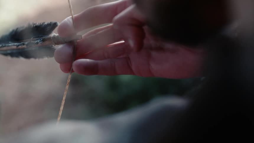 A person is preparing to fire an arrow from a bow
