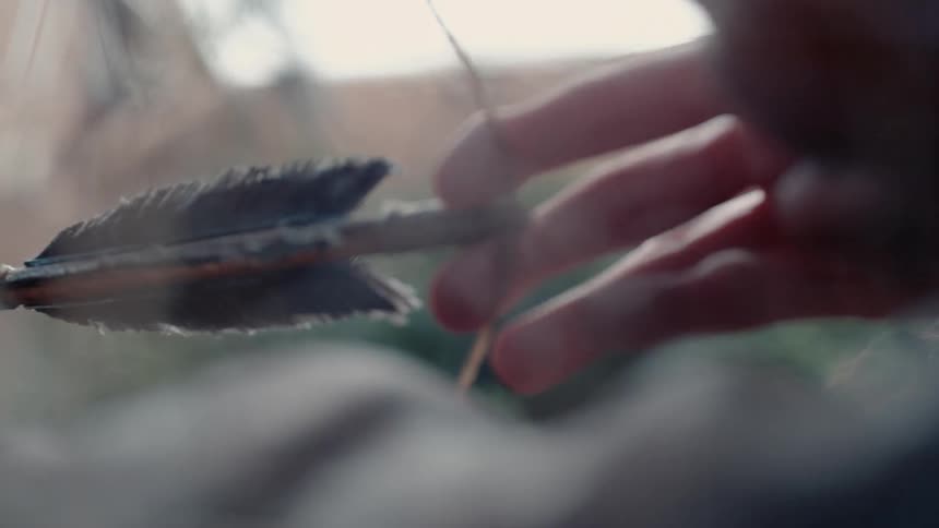Archer releasing his arrow in slow motion