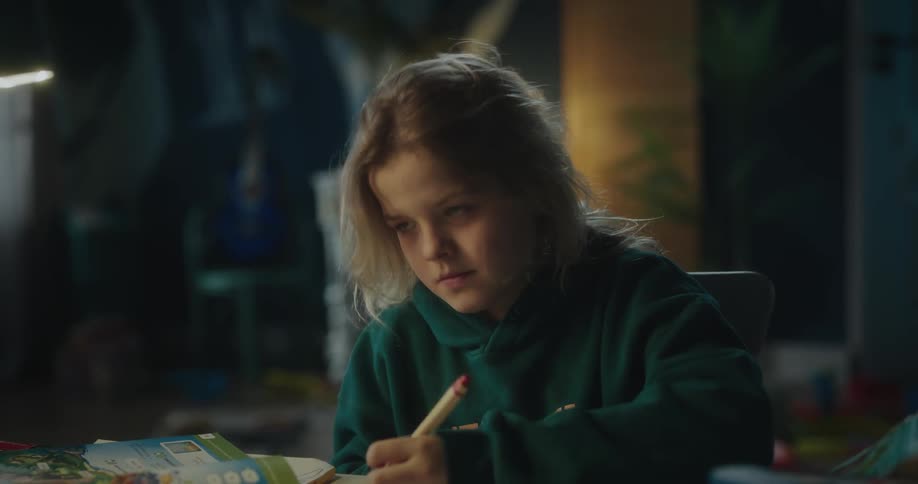 A female child writing on a book indoor