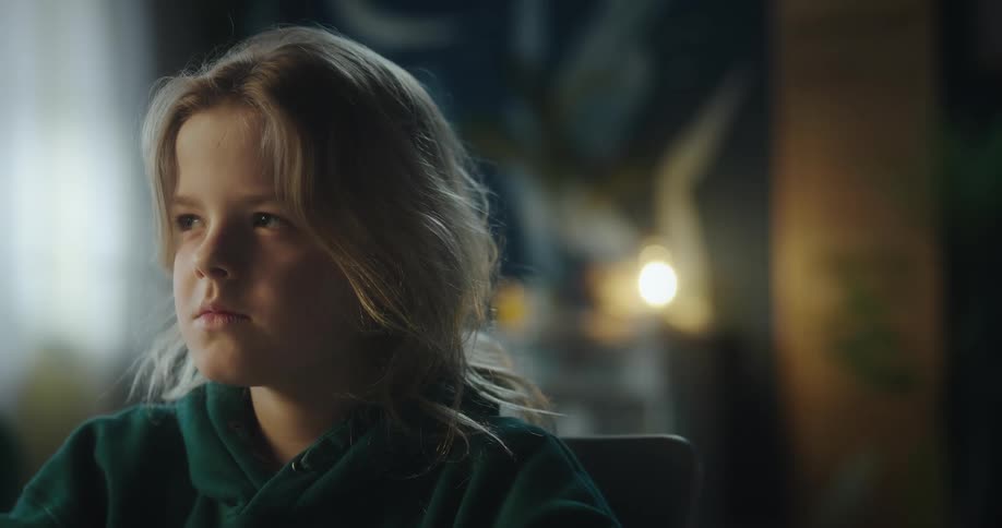 Portrait of a blonde child indoors focused