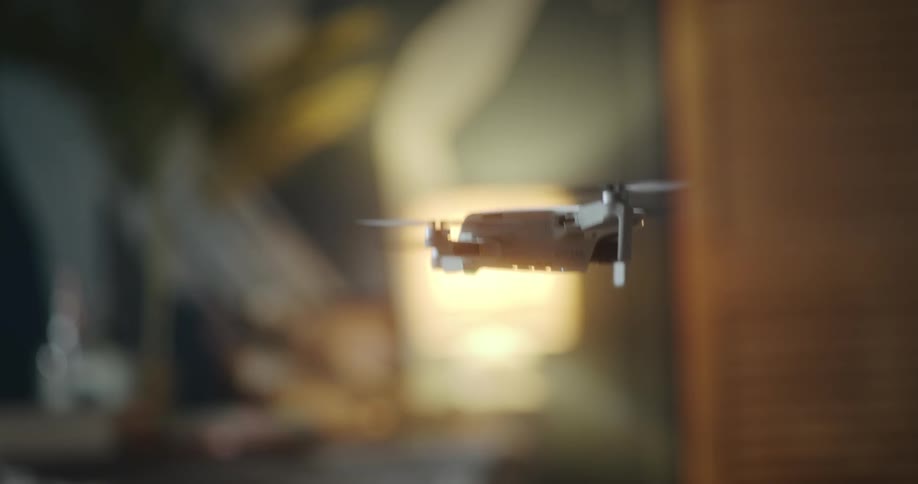 View of a white drone in motion in an indoor home environment