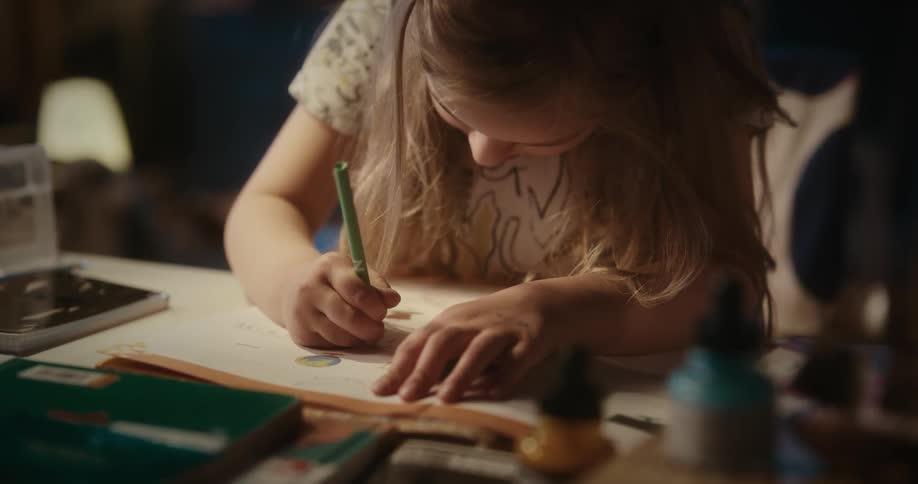 Girl drawing on a white sheet of paper