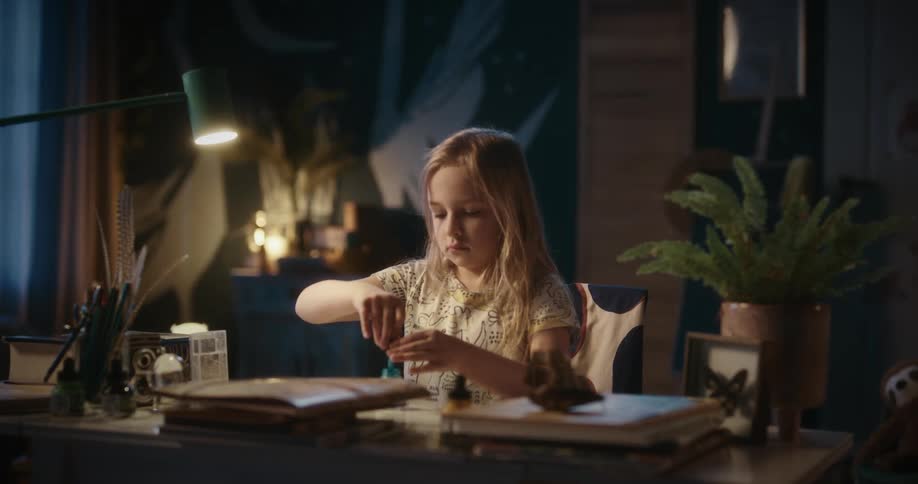 A girl playing with paint on an office table