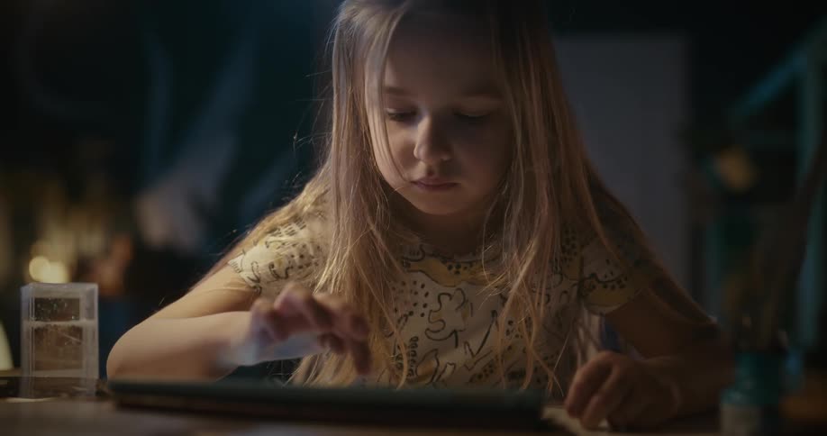A girl clicking on a tablet screen